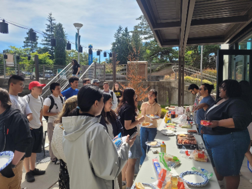 Students eating food at an event 